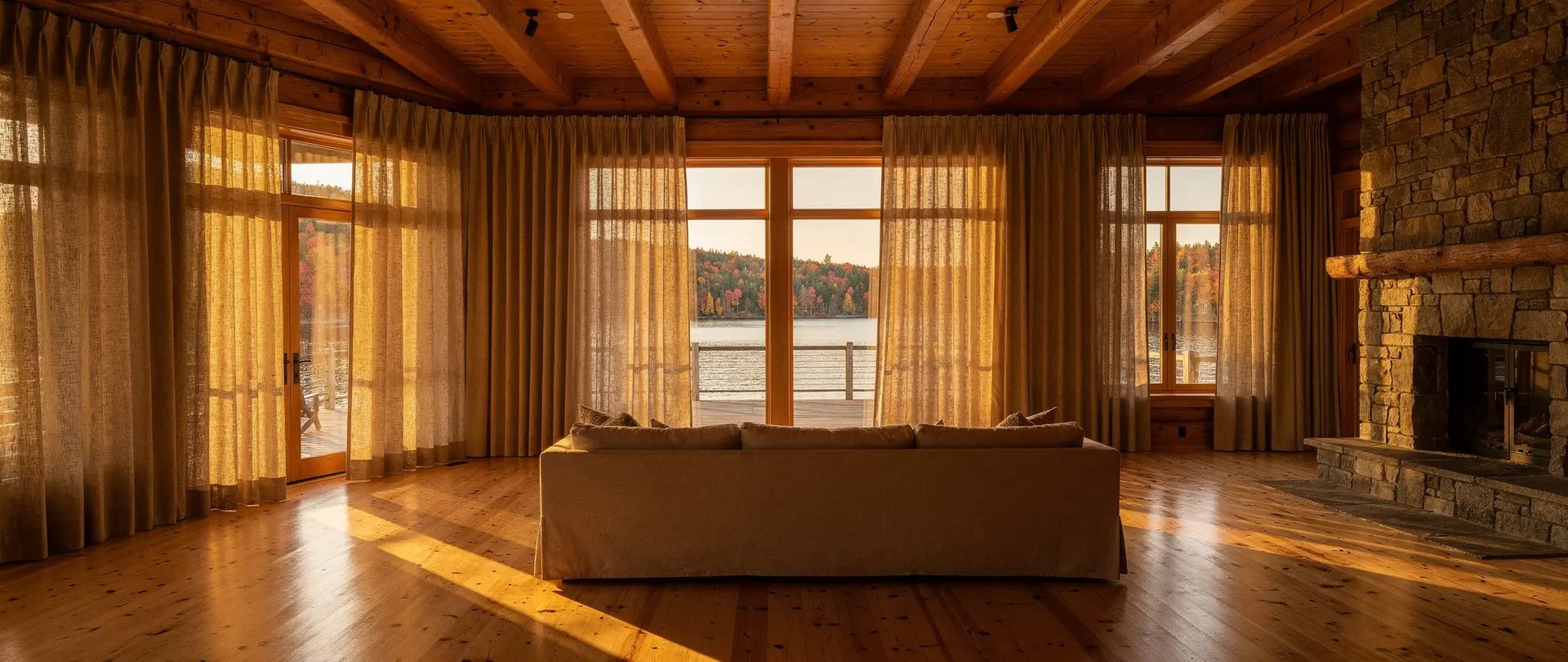 Lakeside chalet living room with tall pleated linen drapes hanging from ceiling to floor